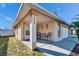 Charming front porch with seating area, providing a relaxing outdoor space for enjoying the neighborhood at 15427 Bama Breeze Pl, Wimauma, FL 33598