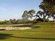 Scenic golf course view with lush green grass, mature trees, and water features, perfect for relaxation and recreation at 1718 Golfview Dr # 1718, Tarpon Springs, FL 34689