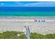 Picturesque aerial view of a beach with clear turquoise water, featuring beachfront condos and hotels at 205 Harrison Ave, Belleair Beach, FL 33786