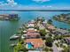 Scenic aerial shot featuring waterfront homes with private docks, lush landscaping, and serene bay views at 205 Harrison Ave, Belleair Beach, FL 33786
