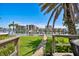 Spacious backyard with well-maintained lawn and waterfront views, perfect for outdoor activities and relaxation at 205 Harrison Ave, Belleair Beach, FL 33786