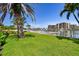 Well-maintained backyard with lush lawn, fenced perimeter, and waterfront views, perfect for outdoor living and recreation at 205 Harrison Ave, Belleair Beach, FL 33786
