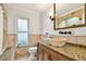 Bathroom featuring a unique bowl sink and granite countertops at 205 Harrison Ave, Belleair Beach, FL 33786