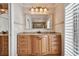 Bathroom with granite countertop vanity and a large rectangular mirror at 205 Harrison Ave, Belleair Beach, FL 33786