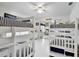 Bedroom with white-painted bunk beds and striped bedding at 205 Harrison Ave, Belleair Beach, FL 33786