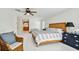 Bright bedroom features light-colored walls, wood accents, and dresser at 205 Harrison Ave, Belleair Beach, FL 33786