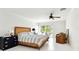Bright bedroom features light-colored walls, wood accents, and sliding door access at 205 Harrison Ave, Belleair Beach, FL 33786