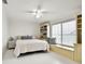 Bright bedroom features a built-in window seat and bookshelves, providing storage and a cozy reading nook at 205 Harrison Ave, Belleair Beach, FL 33786
