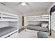 ' bedroom featuring white bunk beds and striped linens at 205 Harrison Ave, Belleair Beach, FL 33786