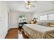 Comfortable bedroom with light walls, a study desk, and windows that provide plenty of natural light at 205 Harrison Ave, Belleair Beach, FL 33786