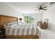 Bright bedroom features light-colored walls, wood accents, and sliding door access at 205 Harrison Ave, Belleair Beach, FL 33786