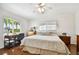 Cozy bedroom with a ceiling fan, study desk, and windows that provide plenty of natural light at 205 Harrison Ave, Belleair Beach, FL 33786