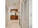 Hallway view leading to bathroom with lots of storage cabinets with doors at 205 Harrison Ave, Belleair Beach, FL 33786