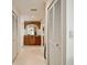 Hallway with multiple doors and an arched wooden bathroom vanity at 205 Harrison Ave, Belleair Beach, FL 33786