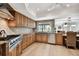 Well-equipped kitchen with stainless steel appliances, granite countertops, and views of the water at 205 Harrison Ave, Belleair Beach, FL 33786