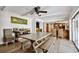 Bright dining area with wood flooring, a rustic dining table, and kitchen view at 205 Harrison Ave, Belleair Beach, FL 33786