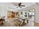 Open-concept living space featuring wood flooring, a large dining table, and kitchen access at 205 Harrison Ave, Belleair Beach, FL 33786