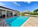 Inviting backyard pool featuring stone pavers and outdoor lounge area, ideal for relaxing and entertaining guests at 205 Harrison Ave, Belleair Beach, FL 33786