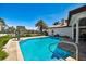 Backyard pool featuring a dolphin statue, brick pavers, and waterfront views, perfect for relaxing or entertaining at 205 Harrison Ave, Belleair Beach, FL 33786