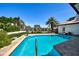 Beautiful swimming pool surrounded by lush landscaping, offering a private oasis at 205 Harrison Ave, Belleair Beach, FL 33786
