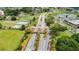 Aerial view of community entrance featuring landscaping, gatehouse and nearby amenities at 2223 Ivan Ct # 59, Sun City Center, FL 33573