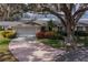 Charming home with a mature tree, landscaped yard, and a two-car garage at 2223 Ivan Ct # 59, Sun City Center, FL 33573