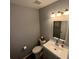 This is a compact half bathroom with modern sink and faucet, toilet, and wood flooring at 2233 Greenhaven Dr # 363, Sun City Center, FL 33573