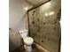 Modern tiled bathroom featuring a glass shower enclosure and safety handrails at 2233 Greenhaven Dr # 363, Sun City Center, FL 33573