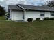 Home exterior showcasing manicured lawn, side entrance and air conditioning unit at 2233 Greenhaven Dr # 363, Sun City Center, FL 33573