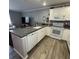 Well-equipped kitchen with white cabinetry, granite counters, and stainless steel appliances at 2233 Greenhaven Dr # 363, Sun City Center, FL 33573