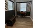 Room featuring wood floors, black accent wall with white framed windows, and antique decor at 2233 Greenhaven Dr # 363, Sun City Center, FL 33573