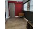 Room features wood floors, a barn door, red wall, and a black and white window design at 2233 Greenhaven Dr # 363, Sun City Center, FL 33573