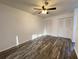 Bedroom featuring wood-look floors, ceiling fan, and white closet doors at 250 Rosery Nw Rd # 220, Largo, FL 33770