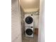 Laundry closet showcasing a stacked washer and dryer unit and shelving for storage at 250 Rosery Nw Rd # 220, Largo, FL 33770