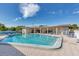 Community swimming pool with brick pavers, ample seating and beautiful turquoise water at 250 Rosery Nw Rd # 220, Largo, FL 33770