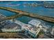 Aerial view of a waterfront building featuring a unique roof design and marina access at 255 Dolphin Pt # 412, Clearwater Beach, FL 33767