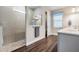 Bathroom featuring a glass enclosed shower with a rain shower head, along with wood-look flooring at 2882 Murray Pass, Odessa, FL 33556