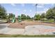 A vibrant playground features slides, swings, and a hopscotch grid, surrounded by lush trees, promising endless fun for children at 2882 Murray Pass, Odessa, FL 33556