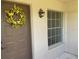 Inviting front door with decorative yellow flower wreath at 3024 Bonaventure Cir # 202, Palm Harbor, FL 34684