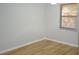 The bedroom includes wood flooring and natural light from the window at 3399 Mermoor Dr # 110, Palm Harbor, FL 34685