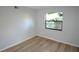 Bedroom featuring wood-look floors and natural lighting at 3399 Mermoor Dr # 110, Palm Harbor, FL 34685