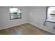 Bedroom featuring wood-look floors and natural lighting at 3399 Mermoor Dr # 110, Palm Harbor, FL 34685