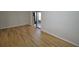 This bedroom features wood floors, natural light, and a glass sliding door that provides access to the outside at 3399 Mermoor Dr # 110, Palm Harbor, FL 34685