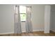 Bedroom features wood laminate flooring and natural light from the window at 3399 Mermoor Dr # 110, Palm Harbor, FL 34685
