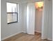 A bedroom featuring wood-look floors, a window, and double door closet with the doors open at 3399 Mermoor Dr # 110, Palm Harbor, FL 34685