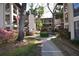 Exterior courtyard featuring green space, walkways, landscaping, and stairs to upper units at 3399 Mermoor Dr # 110, Palm Harbor, FL 34685