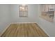 Bright dining area featuring wood-look flooring and a window at 3399 Mermoor Dr # 110, Palm Harbor, FL 34685
