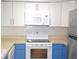 This kitchen features white cabinets, stainless steel appliances, and a white tile backsplash at 3399 Mermoor Dr # 110, Palm Harbor, FL 34685