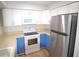 Galley kitchen featuring white cabinets and stainless steel appliances at 3399 Mermoor Dr # 110, Palm Harbor, FL 34685