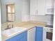 Well-lit kitchen with a sink, counter, and a view from the kitchen window at 3399 Mermoor Dr # 110, Palm Harbor, FL 34685